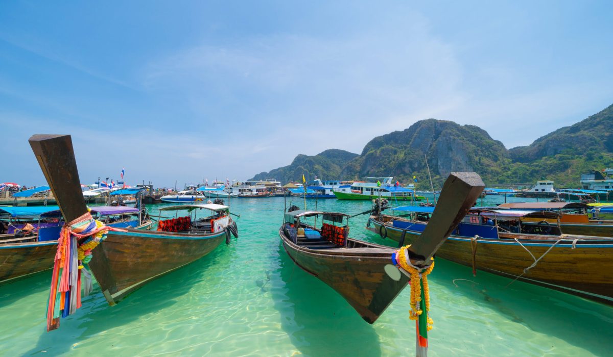 Boats in Phi Phi, Maya beach with blue turquoise seawater, Phuket island in summer season in travel holiday vacation trip. Andaman ocean, Thailand. Tourist attraction with blue sky. Nature landscape.