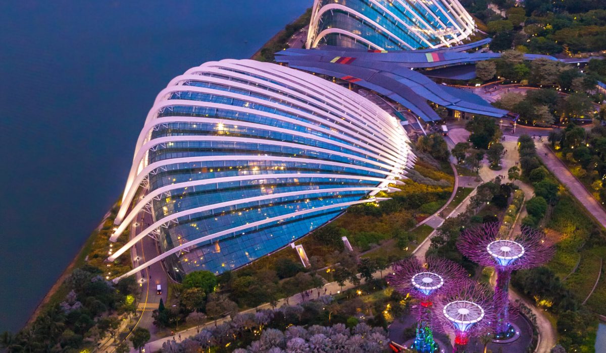 Singapore - 07 July 2018: Aerial night view of the botanical garden, Gardens by the Bay in Singapore. Supertrees Marina Bay. Top view of the glass greenhouse